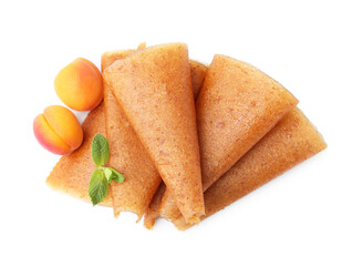 Delicious fruit leather rolls and apricots isolated on white, top view