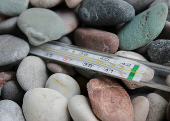 End of Mercury Thermometer Buried in Colored Smooth Stones. Geodetic Experiment Illustrative Photo