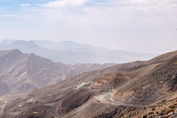 Most visited spot Jebel Jais scenic mountain landscape at Ras Al Khaimah, UAE. Breathtaking rocky peaks, winding roads, and popular tourist destination for hiking, camping, and zipline adventures