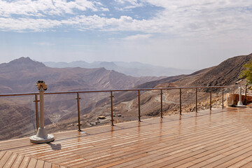Most visited spot Jebel Jais scenic mountain landscape at Ras Al Khaimah, UAE. Breathtaking rocky peaks, winding roads, and popular tourist destination for hiking, camping, and zipline adventures