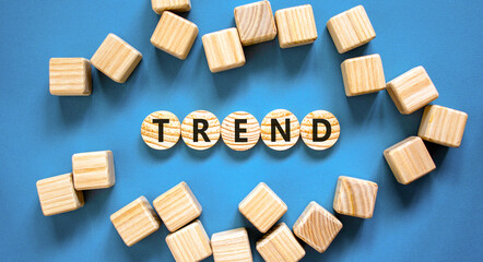 Trend and trending symbol. Concept word Trend on beautiful wooden circles. Beautiful blue table...
