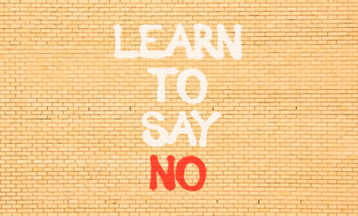 Learn to say no symbol. Concept words phrase Learn to say no on beautiful brown brick wall....