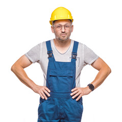 Serious middle-aged construction worker looking at camera, isolated on white background. Front view portrait of a friendly repairman. Craftsman against white wall