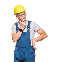 Middle-aged construction worker whispering, isolated on white background. Secret telling. Craftsman against white wall
