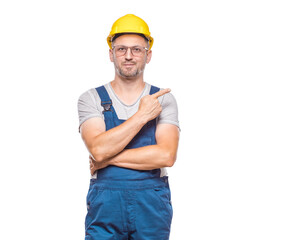 Presentation. Construction worker pointing to blank space - copy space, repairman presenting your product, isolated on white background.Promoter shows space for your text. Craftsman against white wall