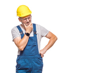Annoyed repairman looking to side, isolated on white background. Confused construction worker. Craftsman against white wall