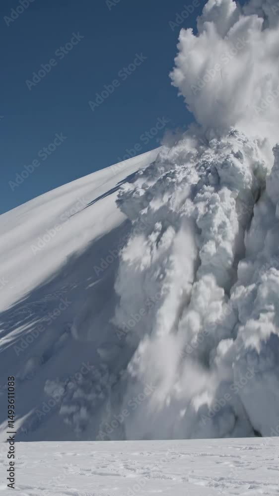 Poster dynamic low-angle shot of a snow avalanche cascading down a mountain, capturing the power and motion