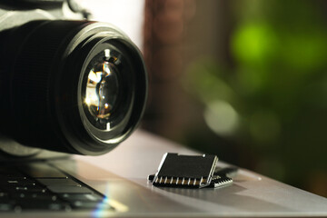 SD memory cards and photo camera on laptop, closeup