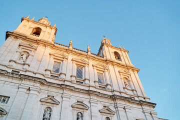 A close-up view of a historic church facade with intricate architectural details, featuring two...