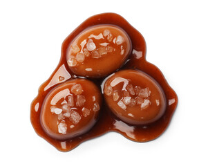 Tasty sweet candies, salt and caramel sauce isolated on white, top view