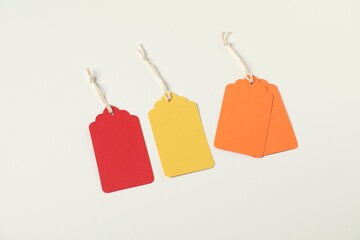 Blank tags with strings on white background, above view