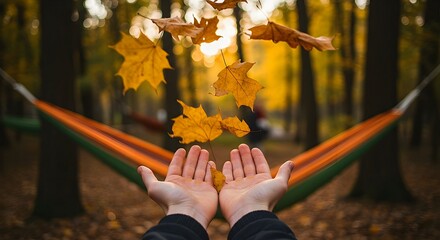 Catching Autumn Leaves in Hands with Hammock in Background