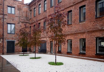 Russia, Moscow, Sergiya Radonezhskogo Street, 15-17.improvement and landscaping of the inner courtyard. White pebbles and red maples, brick walls