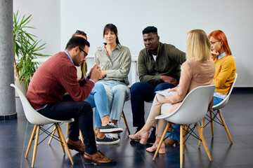 Group Therapy Session with Diverse Participants in a Modern Professional Setting