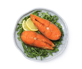 Seafood. Tasty salmon steaks, arugula and lemon isolated on white, top view