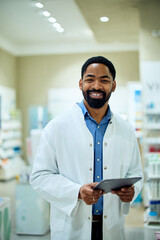 Friendly Pharmacist Smiling in a Modern Store Holding a Digital Tablet