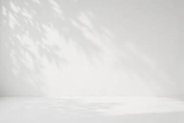 Leaf shadows on a white wall create a minimalist and natural backdrop for product display isolated on white background