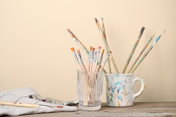 Brush with color paints on wooden table