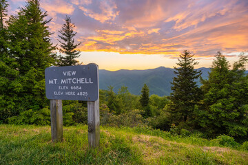 Road trip travel in Appalachian mountains at sunset. Mt. Mitchell Overlook on parkway and woods...
