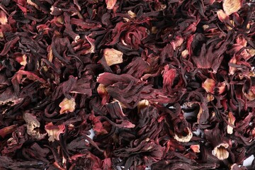 Hibiscus tea. Dried roselle sepals as background, top view