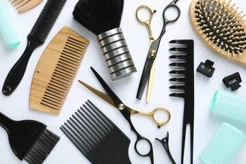 Different hairdresser's tools on white background, flat lay