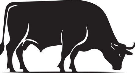Black silhouette of a cow grazing in a field
