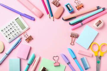 Pens and other stationery on pink background, flat lay. Space for text