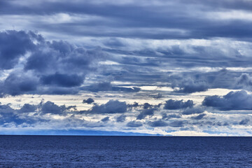 Over the deep waters of Lake Titicaca, stormy clouds and golden light collide in a breathtaking display