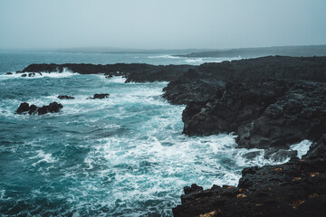 Dramatic Volcanic Coastline with Ocean Waves and Dark Basalt Cliffs in Iceland
