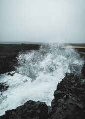 Dramatic Volcanic Coastline with Ocean Waves and Dark Basalt Cliffs in Iceland
