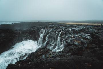 Dramatic Volcanic Coastline with Ocean Waves and Dark Basalt Cliffs in Iceland