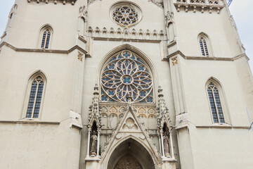 Close-up of a historic Gothic church main entrance, showcasing a beautifully carved tympanum...