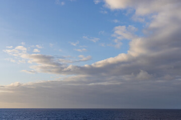 Serene Ocean Horizon Under a Bright Blue Sky with Light Cloudscape