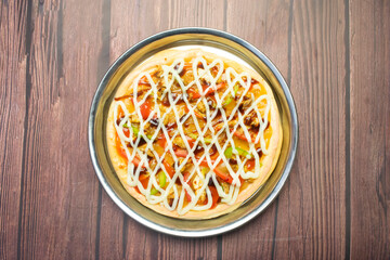 BBQ Pizza served in plate isolated on wooden background top view of Bangladeshi food
