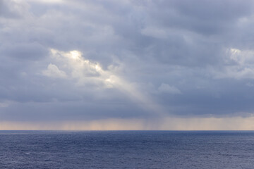 Scenic Ocean View With Dramatic Clouds and Sunbeam Over Horizon