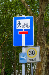 Pedestrian and bicycle path closed sign with speed limit zone in Iserlohn, Germany.