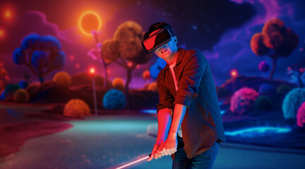 Skilled gamer wearing VR glasses while playing golf at metaverse or golf court with purple sky. Attractive golf player or athlete practicing sport skill while entering in simulated world. Ingenuity.