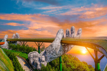 Famous tourist attraction among the tropical jungle in the forests - empty Golden bridge at the top of the Ba Na Hills, Vietnam