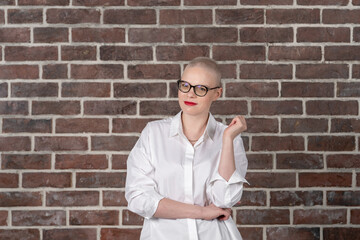 Portrait of a beautiful young caucasian woman with shaved head. Female cancer survivor. Smiling...