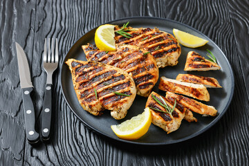 grilled chicken breast with lemon on a plate