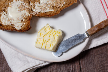 Homemade artisan bread with butter on a light background.