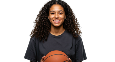 Joyful young woman, with curly black hair,  wearing a dark t-shirt and smiling,  is presented in a  shot holding a basketball.