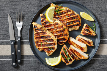 grilled chicken breast with lemon on a plate