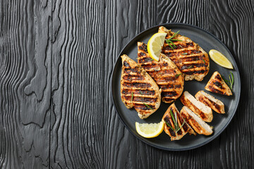grilled chicken breast with lemon on a plate