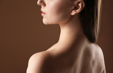 Beautiful woman on brown background, back view