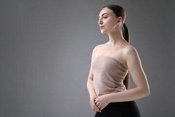 Obraz premium Portrait of beautiful woman on grey background. Space for text