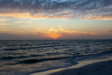 Dramatic sunset on gorgeous white quartz sand beach on Siesta Key in Sarasota, Florida