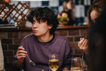 A group of friends dining together, enjoying delicious food and friendly conversation over drinks.