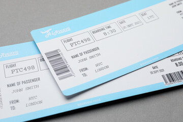 Travel agency. Flight tickets on grey background, closeup