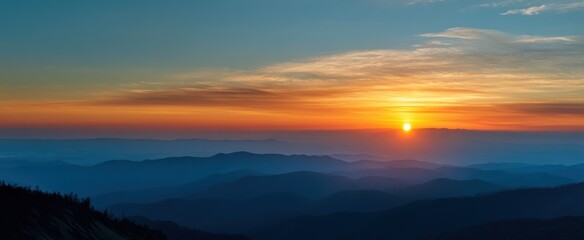 Fototapeta premium The breathtaking sunset over distant mountains creating a serene landscape view.